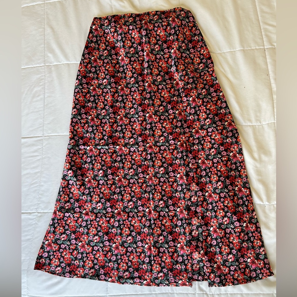 Fancesca’s midi skirt with slit on left leg. Runs true to size.